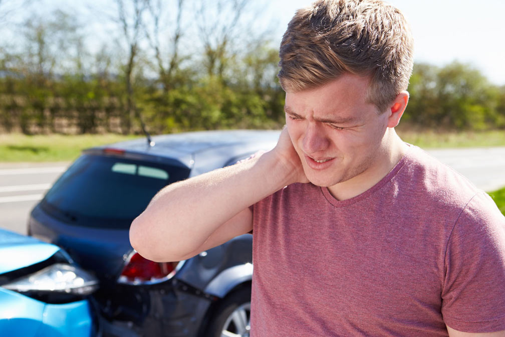 Women in car holding neck in pain
